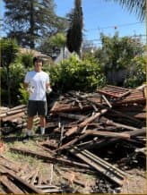 Team member standing on large wood debris pile